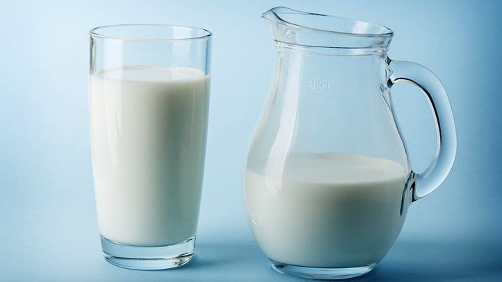 a pitcher and glass of milk