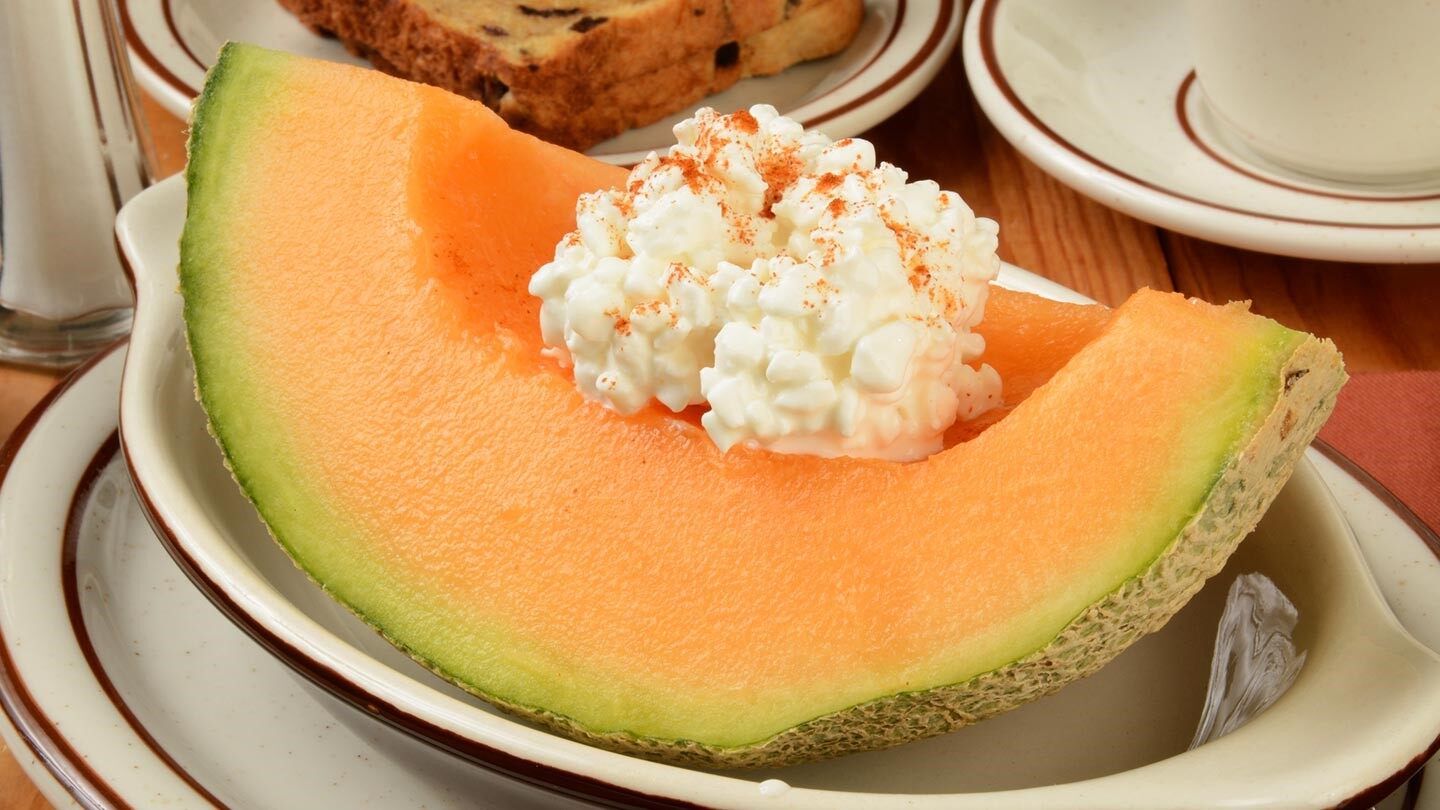 a wedge of cantaloupe with cottage cheese