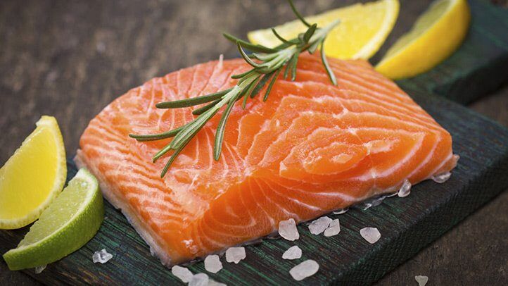 a salmon fillet with a sprig of rosemary